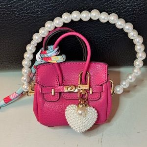 Pink mini handbag with pearl strap
